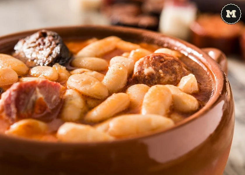 Asturian fabes in a clay pot with chorizo, black pudding and potatoes