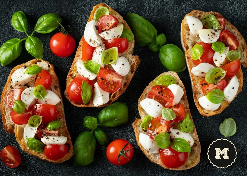 Homemade cornbread with mozzarella balls, cherry tomatoes and basil