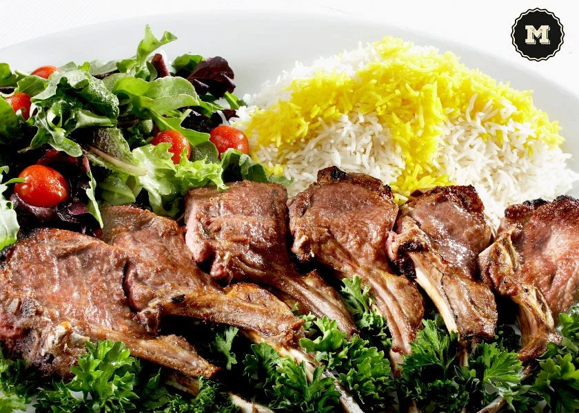 Lamb roasted in a wood-fired oven with salad and rice